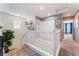 Bright hallway with white railing leads to various rooms and features neutral carpeting at 4129 Chamisa Cove St, Las Vegas, NV 89115