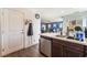 Modern kitchen with dark cabinets, stainless steel appliances, and an adjacent living room at 4129 Chamisa Cove St, Las Vegas, NV 89115