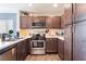Modern kitchen featuring stainless steel appliances, dark wood cabinets, and sleek countertops at 4129 Chamisa Cove St, Las Vegas, NV 89115