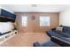 Comfortable living room with a large TV, sectional sofa, and ample seating space at 4129 Chamisa Cove St, Las Vegas, NV 89115