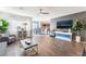 Bright, open-concept living room with hardwood floors, grey and blue accent walls, and comfortable seating at 4129 Chamisa Cove St, Las Vegas, NV 89115