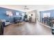 Spacious living room with hardwood floors, blue accent wall, and ample natural light at 4129 Chamisa Cove St, Las Vegas, NV 89115