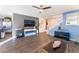 Open-concept living room with hardwood floors, entertainment center, and access to the dining area at 4129 Chamisa Cove St, Las Vegas, NV 89115