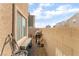 Side yard with block wall, small bench, barbeque, and miscellaneous items on a gravel bed at 4129 Chamisa Cove St, Las Vegas, NV 89115