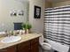 Bathroom features granite counters, and shower with black and white striped curtain at 4200 S Valley View Blvd # 3078, Las Vegas, NV 89103