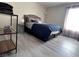 Bedroom with neutral colors, wood floors, bright window, and shelving unit at 4200 S Valley View Blvd # 3078, Las Vegas, NV 89103