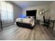 Modern bedroom with stylish decor, light wood flooring, and a large black upholstered headboard at 4200 S Valley View Blvd # 3078, Las Vegas, NV 89103