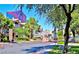 Community entrance to a neighborhood featuring a guard house and lush trees at 4200 S Valley View Blvd # 3078, Las Vegas, NV 89103