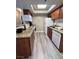 Galley kitchen includes granite countertops, wood cabinets and appliances at 4200 S Valley View Blvd # 3078, Las Vegas, NV 89103