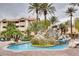 Outdoor pool area with palm trees, rock waterfall and lounge chairs for resident relaxation at 4200 S Valley View Blvd # 3078, Las Vegas, NV 89103