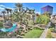 A luxurious community pool with waterfall feature, lounge chairs, and tropical landscaping at 4200 S Valley View Blvd # 3078, Las Vegas, NV 89103