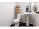 Bathroom featuring a pedestal sink, dark wood floors and toilet at 4509 Paseo Del Ray Dr, Las Vegas, NV 89121