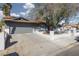 Side view of gray single-story home showing the driveway, garage and white-brick exterior walls at 4509 Paseo Del Ray Dr, Las Vegas, NV 89121