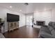 Cozy living room featuring a modern fireplace, hardwood floors, and a sliding glass door at 4509 Paseo Del Ray Dr, Las Vegas, NV 89121