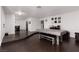 Inviting living area featuring hardwood floors, a game table, and views into the dining room at 4509 Paseo Del Ray Dr, Las Vegas, NV 89121