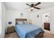Bedroom with a ceiling fan, large window, and a view into the bathroom at 4612 Townwall St, Las Vegas, NV 89115