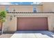 Two-story home with a two-car garage and desert landscaping at 4612 Townwall St, Las Vegas, NV 89115