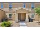 Inviting townhouse exterior with a covered porch, well-maintained landscaping, and neutral color scheme at 4612 Townwall St, Las Vegas, NV 89115