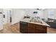 Open-concept kitchen with an island sink and a clear view into the living and dining spaces at 4612 Townwall St, Las Vegas, NV 89115
