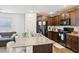 Well-equipped kitchen featuring granite countertops, a center island, and a view to the living area at 4612 Townwall St, Las Vegas, NV 89115