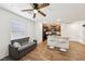 Cozy living space adjacent to the kitchen with a window and wood-look flooring at 4612 Townwall St, Las Vegas, NV 89115