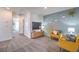 Open bonus room with sunshine wall art, two yellow armchairs, and gray carpet at 5027 Sage Mesa Ave # Lot 141, Las Vegas, NV 89139
