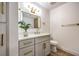 Modern bathroom with white vanity, gold hardware, a framed mirror and bright lighting at 5101 Village Dr, Las Vegas, NV 89142
