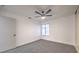 Simple bedroom with neutral carpeting, standard window and ceiling fan at 5101 Village Dr, Las Vegas, NV 89142