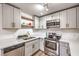 Modern kitchen featuring stainless steel appliances, ample white cabinets, and light countertops, providing a clean and functional space at 5101 Village Dr, Las Vegas, NV 89142