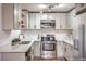 This updated kitchen has stainless steel appliances, light gray cabinets, and sleek white countertops at 5101 Village Dr, Las Vegas, NV 89142