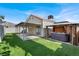 Backyard featuring artificial grass, a covered patio and a hot tub with gazebo at 5762 Yerington Ave, Las Vegas, NV 89110