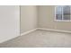 Bedroom featuring neutral carpet, white trim and window at 5762 Yerington Ave, Las Vegas, NV 89110