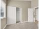 Cozy bedroom featuring neutral walls, carpet, and a closet with sliding doors at 5762 Yerington Ave, Las Vegas, NV 89110