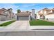 Charming home featuring a 2-car garage, red tile roof, and well-maintained artificial lawn at 5762 Yerington Ave, Las Vegas, NV 89110