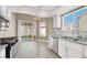Updated kitchen featuring white cabinets, stainless steel appliances, and backyard views at 5762 Yerington Ave, Las Vegas, NV 89110