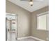 Bright space with gray wood flooring, ceiling fan, and a glimpse of the kitchen at 5762 Yerington Ave, Las Vegas, NV 89110