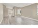 Spacious living room featuring stylish gray wood flooring and natural light at 5762 Yerington Ave, Las Vegas, NV 89110