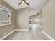 Open-concept floor plan with wood flooring, view into living room with fireplace at 5762 Yerington Ave, Las Vegas, NV 89110