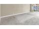Spacious living room featuring plush carpeting and a sliding door, perfect for relaxation and entertaining at 5762 Yerington Ave, Las Vegas, NV 89110
