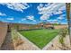 Beautiful backyard with green turf, decorative rock, garden bed, and gazebo with seating at 6325 Gambetta St, Las Vegas, NV 89115