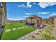 Beautiful backyard featuring artificial turf, a gazebo with seating, and landscaped borders at 6325 Gambetta St, Las Vegas, NV 89115