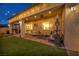 Spacious backyard featuring a covered patio, lush lawn, string lights, and cozy seating areas perfect for relaxing at 6325 Gambetta St, Las Vegas, NV 89115