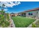 Wide backyard featuring green turf, privacy wall, and a gazebo offering an inviting outdoor space at 6325 Gambetta St, Las Vegas, NV 89115