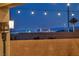 Inviting backyard view overlooking the vibrant cityscape of Las Vegas at twilight, complete with decorative string lights at 6325 Gambetta St, Las Vegas, NV 89115