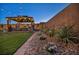 Backyard gazebo seating area amidst lush landscaping with rocks and plants, ideal for relaxing outdoors at 6325 Gambetta St, Las Vegas, NV 89115