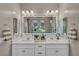 Bathroom with double sinks and large, decorative mirror at 6325 Gambetta St, Las Vegas, NV 89115