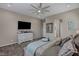 A bedroom with comfortable-looking bed and dresser with television at 6325 Gambetta St, Las Vegas, NV 89115