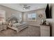 Spacious bedroom featuring a decorative ceiling fan, cozy carpet, and plenty of natural light from the window at 6325 Gambetta St, Las Vegas, NV 89115