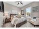 Comfortable bedroom with a well-decorated bed and a cozy armchair near a window at 6325 Gambetta St, Las Vegas, NV 89115