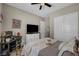This comfortable bedroom showcases a ceiling fan, television, and a dedicated workspace with a desk and computer at 6325 Gambetta St, Las Vegas, NV 89115